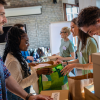 Group of volunteers with working in community charity donation center.